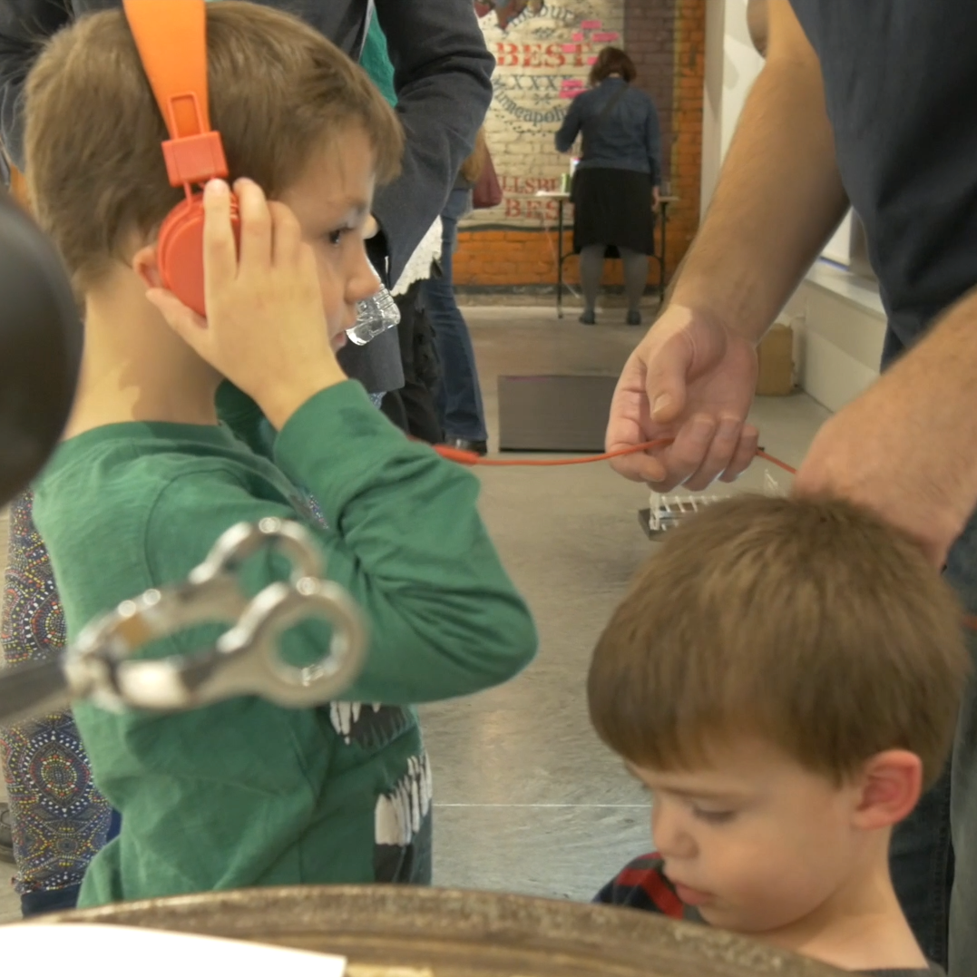 Alexandra's kids wearing headphones